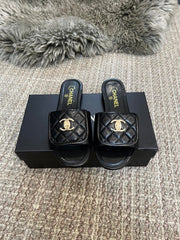 Luxury diamond-quilted flat slides with metal embellishments
