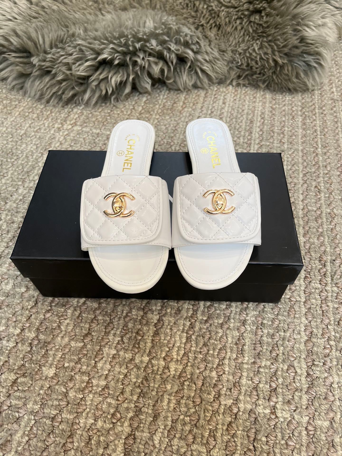 Luxury diamond-quilted flat slides with metal embellishments